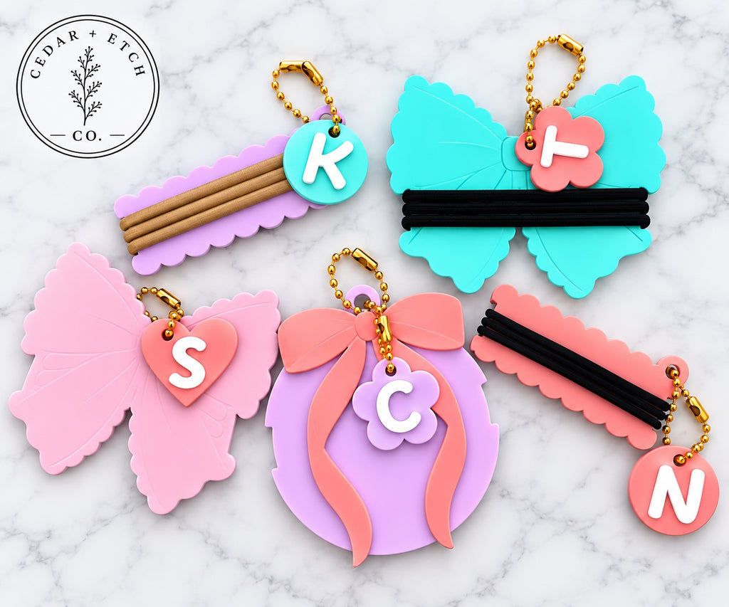 Initial coquette hair tie holder keychains and bag tags in colorful glossy acrylic