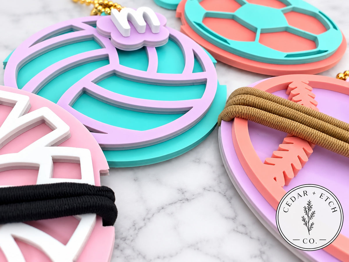 Close-up of glossy acrylic sports hair tie holder keychains and bag tags